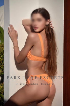 Slender brunette Italian girl in an orange bikini