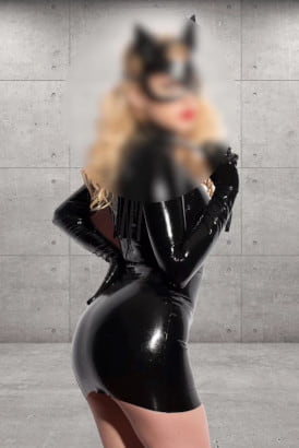 Blonde girl in a black latex catsuit
